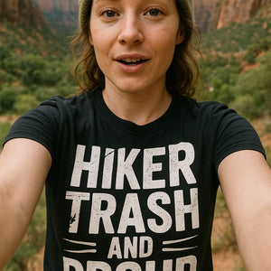 "Hiker Trash and Proud" black best backpacking shirts, photographed as backpacking lover gift