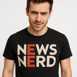 Close-up of the "News Nerd" beige print on a premium Bella+Canvas black journalist t shirt
