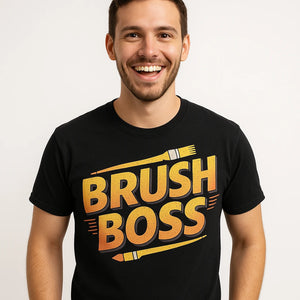 Close-up of the "Brush Boss" gold print on a premium Bella+Canvas black painting t shirt