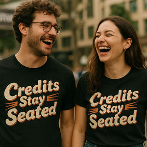 Person wearing the black graphic tee graphic tee - "Credits Stay Seated" design