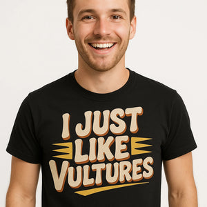 Close-up of the "I Just Like Vultures" beige print on a premium Bella+Canvas black vulture t shirt