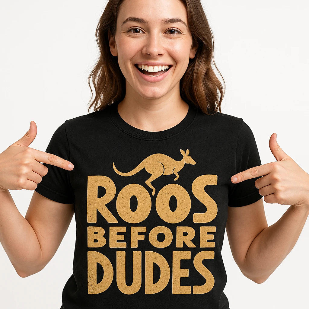 Close-up of the "Roos Before Dudes" tan print on a premium Bella+Canvas black kangaroo pocket t shirt