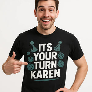 Close-up of the "Its Your Turn Karen" white print on a premium Bella+Canvas black board game tee