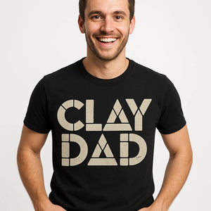 Close-up of the "Clay Dad" light gray print on a premium Bella+Canvas black body sculpting t shirt