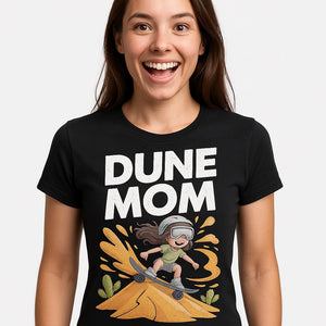 Close-up of the "Dune Mom" gold print on a premium Bella+Canvas black sandboarding t shirt