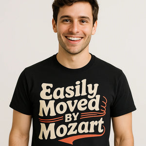 Close-up of the "Easily Moved By Mozart" cream print on a premium Bella+Canvas black classical music shirts