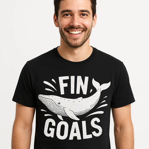 Close-up of the "Fin Goals" white print on a premium Bella+Canvas black killer whale t shirt