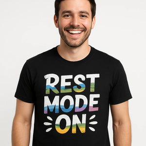 Close-up of the "Rest Mode On" white print on a premium Bella+Canvas black relaxing t shirt