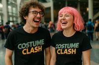 Two people are joyfully laughing together. The person on the left has curly brown hair, wears glasses, and a black 