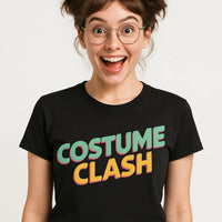 A person with wavy brown hair styled in two buns, wearing round glasses and a black t-shirt with colorful text that says 
