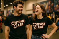 Two people are standing indoors at an event, both wearing matching black T-shirts with the words 