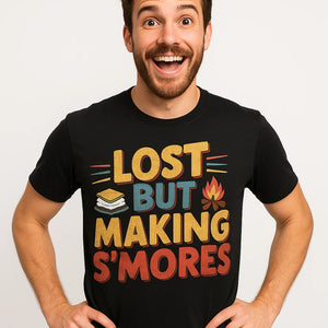 Close-up of the "Lost But Making S'Mores" brown print on a premium Bella+Canvas black camp shirts for men