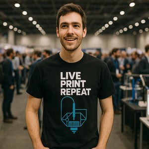 Lifestyle shot of the "Live Print Repeat" black 3d printing t shirt in a real-world setting
