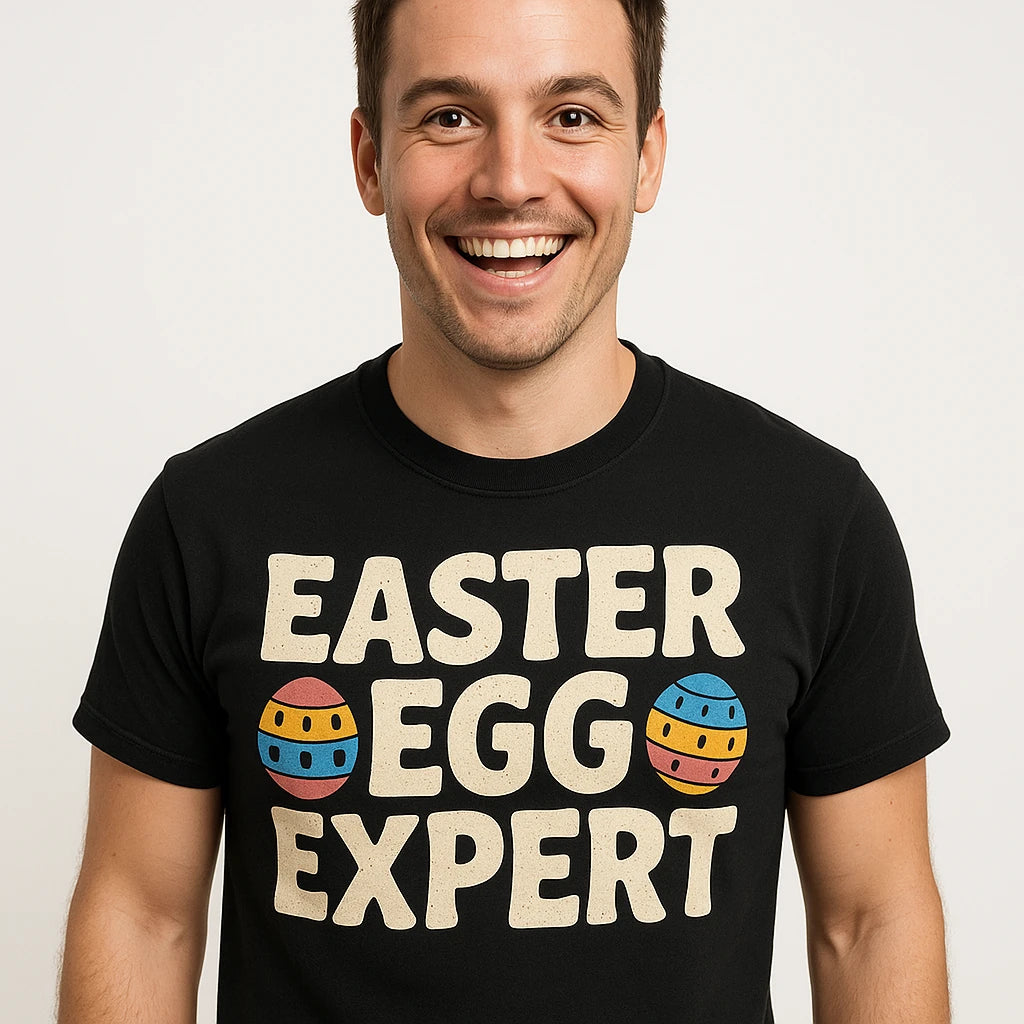 Close-up of the "Easter Egg Expert" beige print on a premium Bella+Canvas black easter shirts