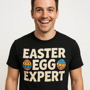 Close-up of the "Easter Egg Expert" beige print on a premium Bella+Canvas black easter shirts