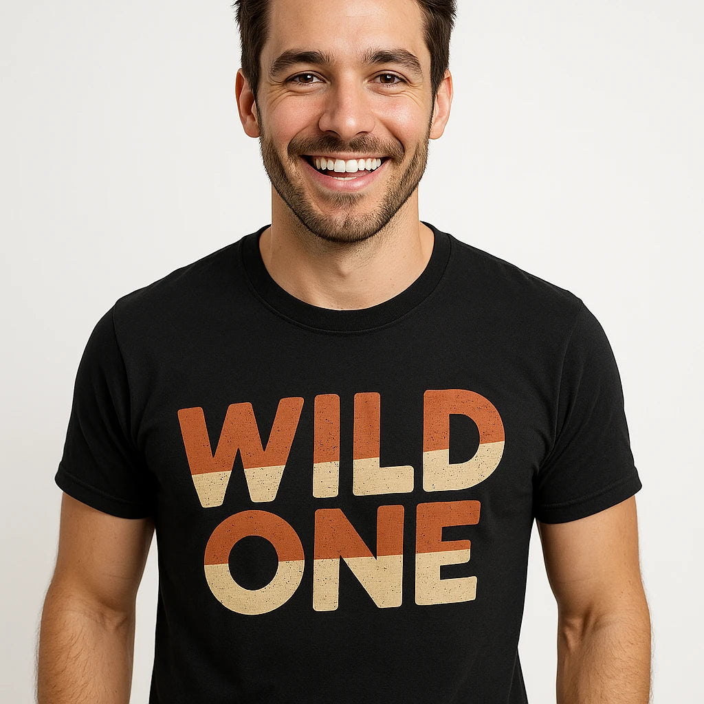 Close-up of the "Wild One" orange print on a premium Bella+Canvas black jaguar shirts