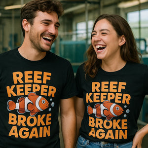 Person wearing the black clownfish shirts graphic tee - "Reef Keeper Broke Again" design