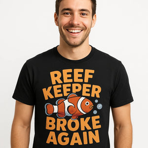 Close-up of the "Reef Keeper Broke Again" gold print on a premium Bella+Canvas black clownfish shirts