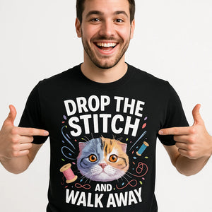 Close-up of the "Drop the Stitch and Walk Away" white print on a premium Bella+Canvas black t shirt sewing pattern