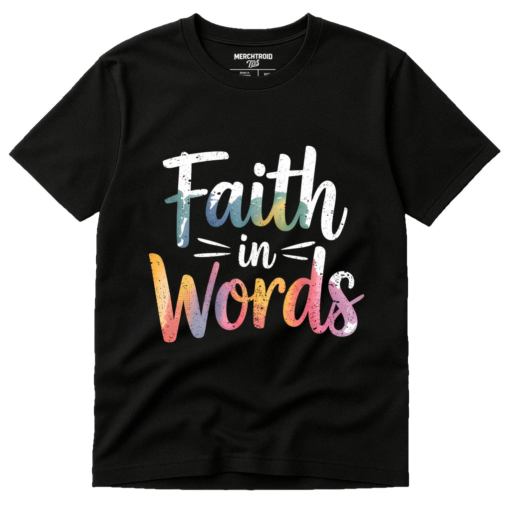 A black t-shirt with the text "Faith in Words" written in a colorful, artistic font. The style blends shades of white, blue, orange, pink, and purple, creating a gradient effect.