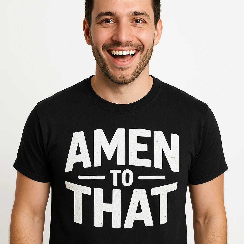 A person with short dark hair and a beard is smiling widely. They are wearing a black T-shirt with the text "AMEN TO THAT" in bold white letters.