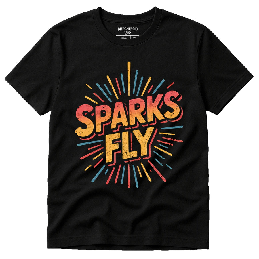 A black t-shirt featuring the words "SPARKS FLY" in bold, colorful letters. The text is surrounded by a burst of multicolored lines, adding a dynamic and energetic design.