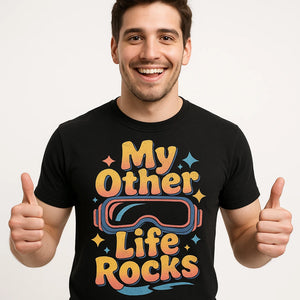 Close-up of the "My Other Life Rocks" gold print on a premium Bella+Canvas black virtual reality t shirt