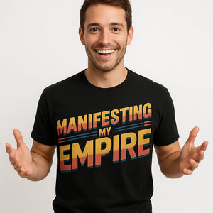 Close-up of the "Manifesting My Empire" orange print on a premium Bella+Canvas black entrepreneurs shirts