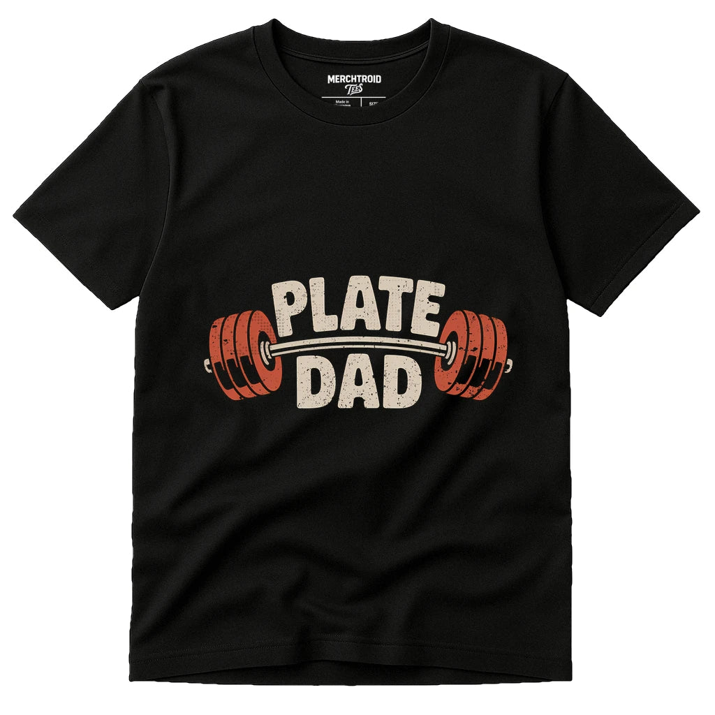 A black t-shirt with the text "PLATE DAD" printed on it, featuring a barbell with red weight plates graphic.