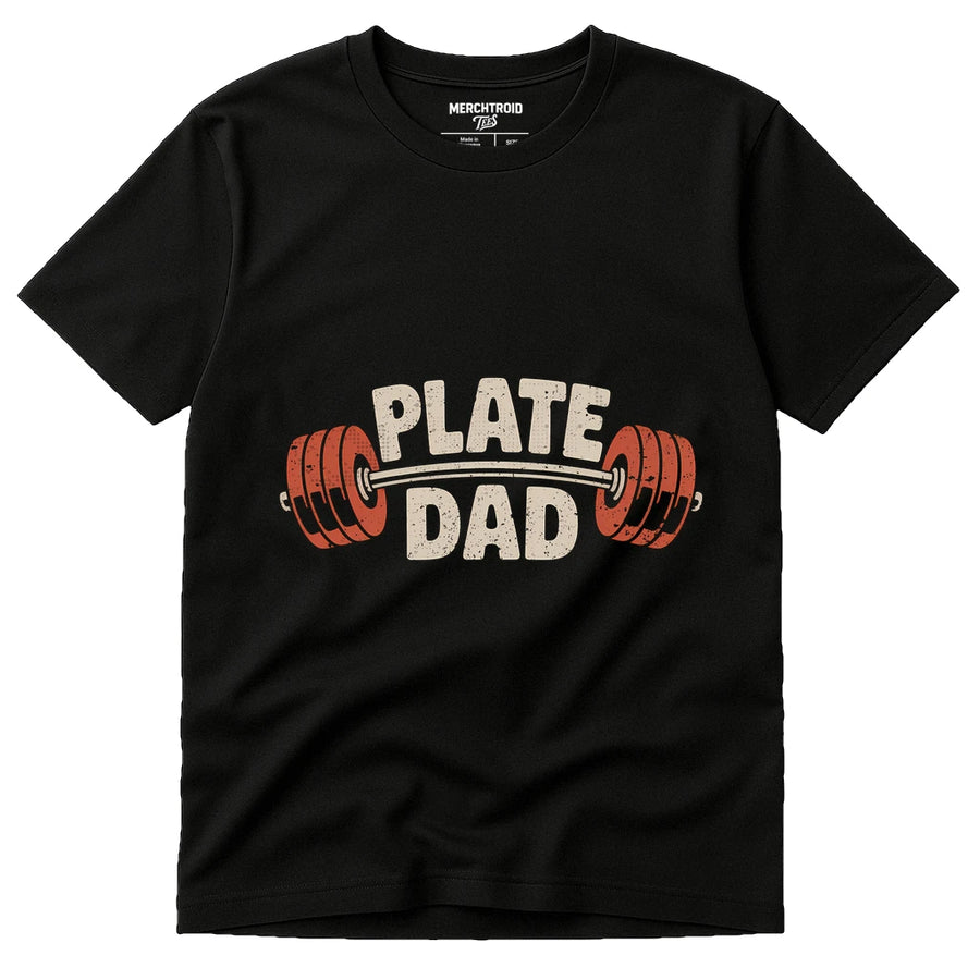 A black t-shirt with the text "PLATE DAD" printed on it, featuring a barbell with red weight plates graphic.