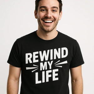 Close-up of the "Rewind My Life" white print on a premium Bella+Canvas black graphic tee