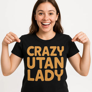 Close-up of the "Crazy Utan Lady" gold print on a premium Bella+Canvas black orangutan shirts