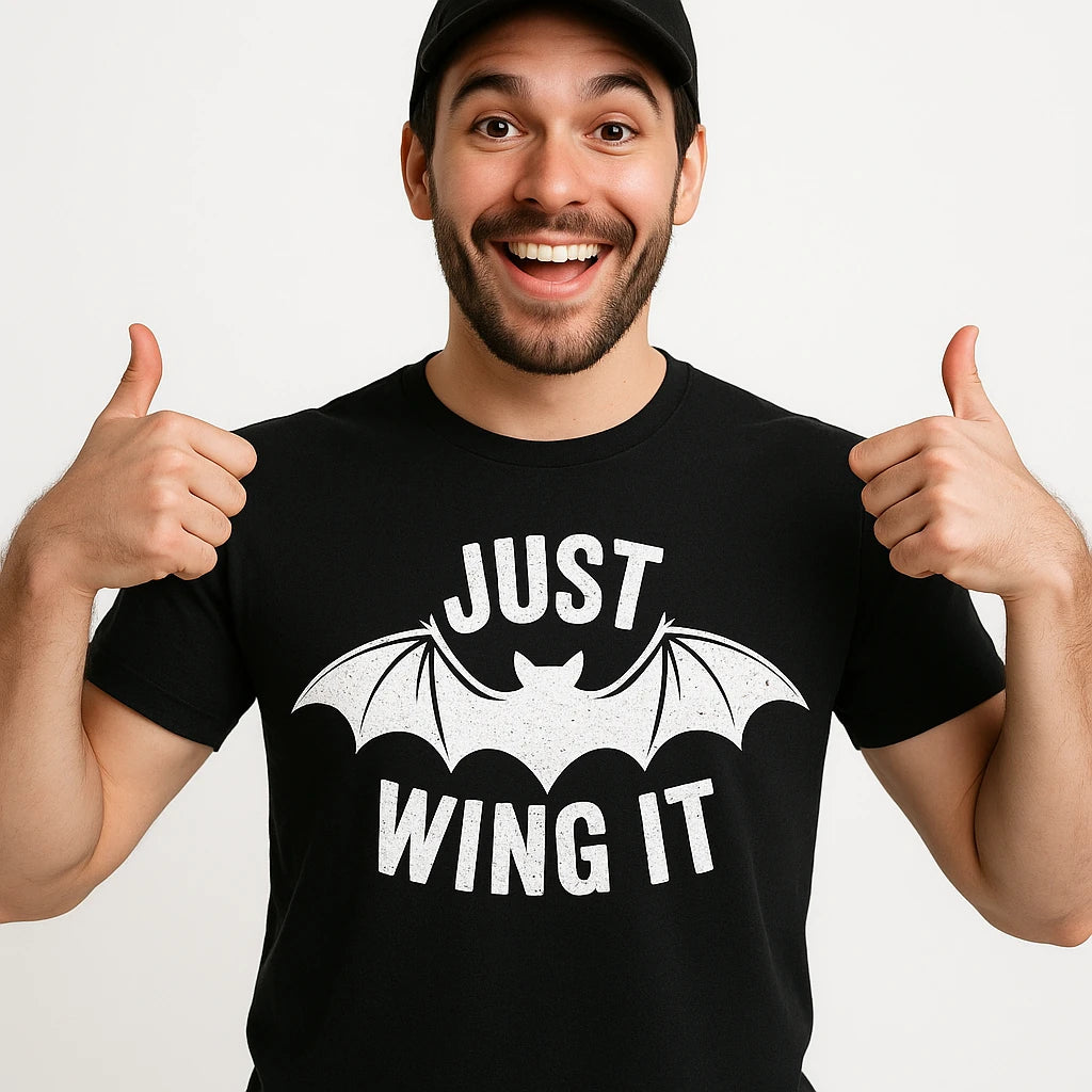 Close-up of the "Just Wing It" white print on a premium Bella+Canvas black bat t shirt