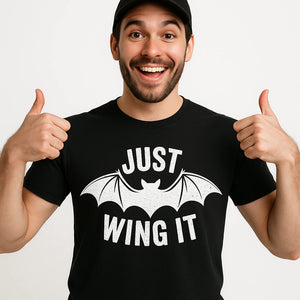 Close-up of the "Just Wing It" white print on a premium Bella+Canvas black bat t shirt