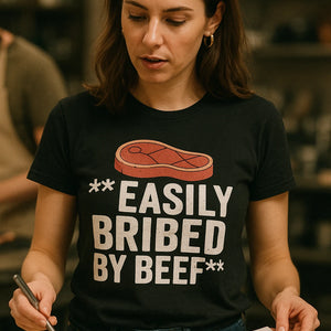 "Easily Bribed By Beef" black steak shirts, photographed as gifts for a steak lover
