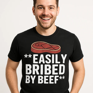 Close-up of the "Easily Bribed By Beef" white print on a premium Bella+Canvas black steak shirts