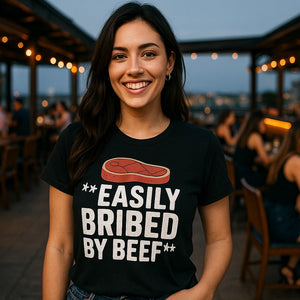 Lifestyle shot of the "Easily Bribed By Beef" black steak shirts in a real-world setting