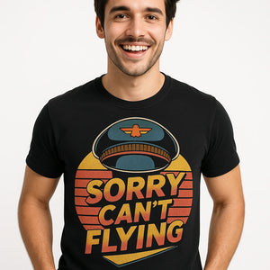 Close-up of the "Sorry Can'T Flying" orange print on a premium Bella+Canvas black pilot shirts