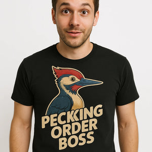 Close-up of the "Pecking Order Boss" beige print on a premium Bella+Canvas black woodpecker t shirt