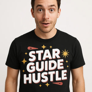 Close-up of the "Star Guide Hustle" white print on a premium Bella+Canvas black astrology tee