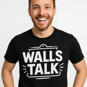 Close-up of the "Walls Talk" white print on a premium Bella+Canvas black interior designer t shirt