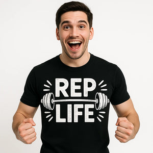 Close-up of the "Rep Life" white print on a premium Bella+Canvas black personal trainer t shirt