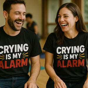 Person wearing the black first time parents t shirts graphic tee - "Crying Is My Alarm" design