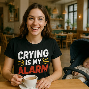 Lifestyle shot of the "Crying Is My Alarm" black first time parents t shirts in a real-world setting