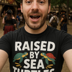 "Raised By Sea Turtles" black pirate shirts for ladies, photographed as gifts for pirate lovers