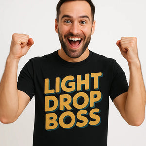 Close-up of the "Light Drop Boss" gold print on a premium Bella+Canvas black mens shirts for new years eve