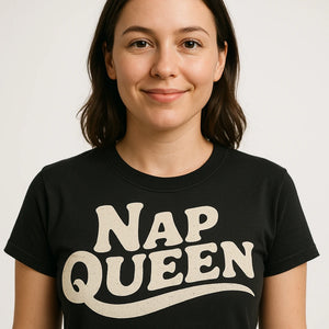 Close-up of the "Nap Queen" cream print on a premium Bella+Canvas black relaxing t shirt