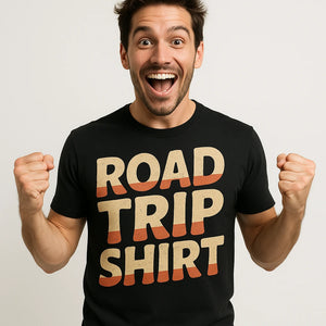Close-up of the "Road Trip Shirt" tan print on a premium Bella+Canvas black adventure travel t shirt