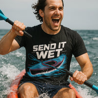 A person kayaking in the ocean, wearing a black T-shirt with the text 