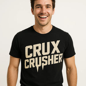 Close-up of the "Crux Crusher" beige print on a premium Bella+Canvas black rock climbing tee shirts